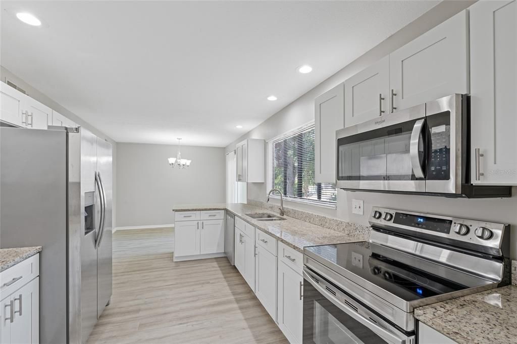 Chandelier, Interior, Kitchen, Recessed Lighting, Stainless Steel Appliances, Wood Texture Flooring
