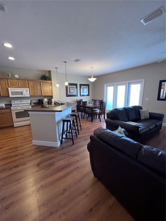 Dining room, Interior, Kitchen, Living room, Pendant Lights, Recessed Lighting, Stainless Steel Appliances, Wood Texture Flooring