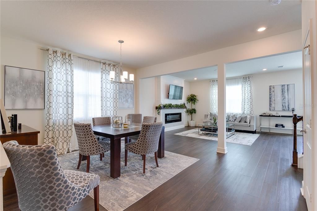 Chandelier, Dining room, Fireplace, Interior, Living room, Pendant Lights, Recessed Lighting, Wood Texture Flooring