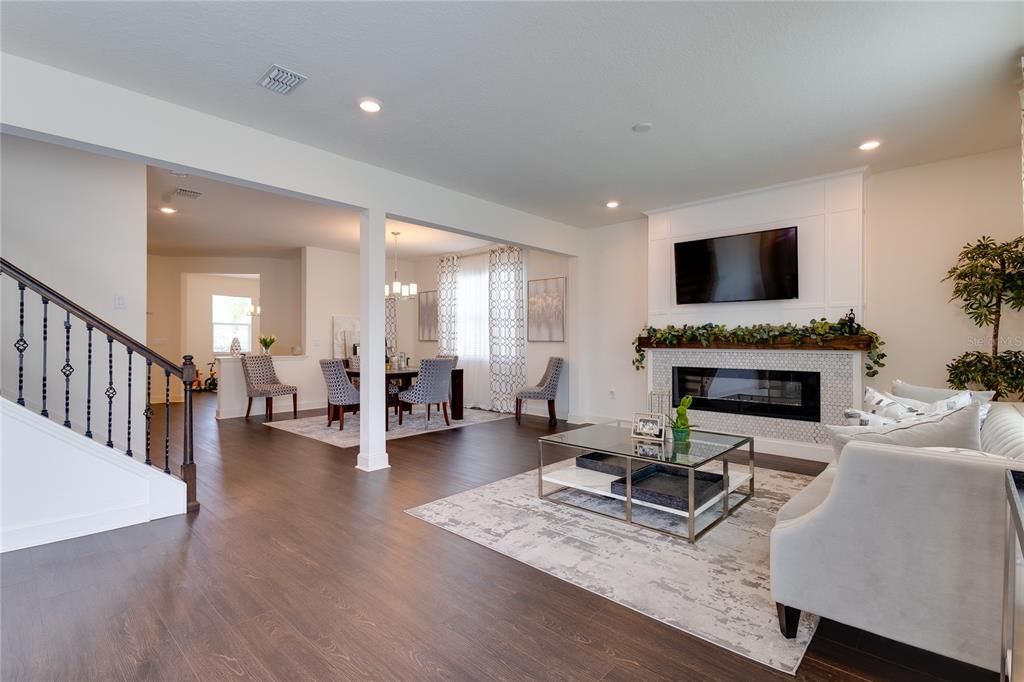 Chandelier, Dining room, Fireplace, Interior, Living room, Pendant Lights, Recessed Lighting, Wood Texture Flooring