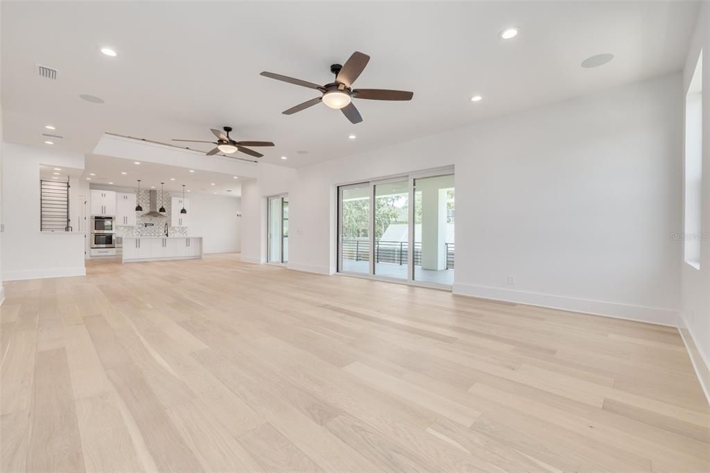 Empty room, Interior, Kitchen, Recessed Lighting, Stainless Steel Appliances, Wood Texture Flooring
