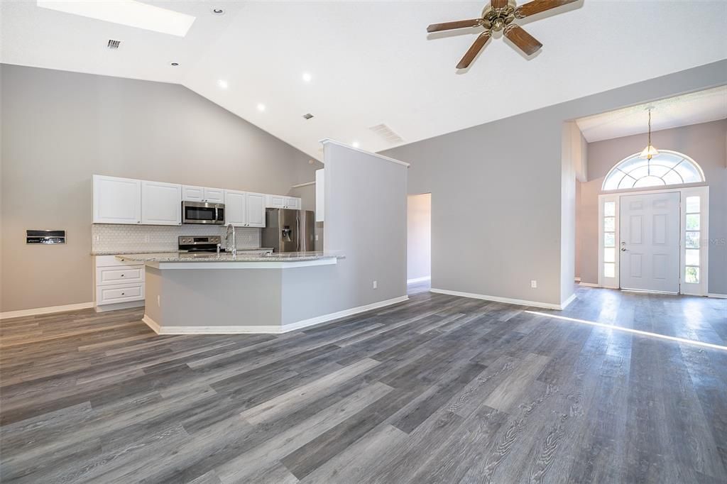 Empty room, Interior, Kitchen, Pendant Lights, Recessed Lighting, Stainless Steel Appliances, Wood Texture Flooring