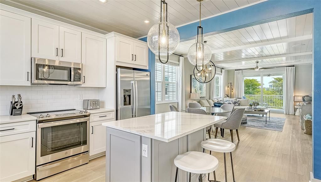 Chandelier, Dining room, Interior, Kitchen, Living room, Pendant Lights, Recessed Lighting, Stainless Steel Appliances, Wood Texture Flooring