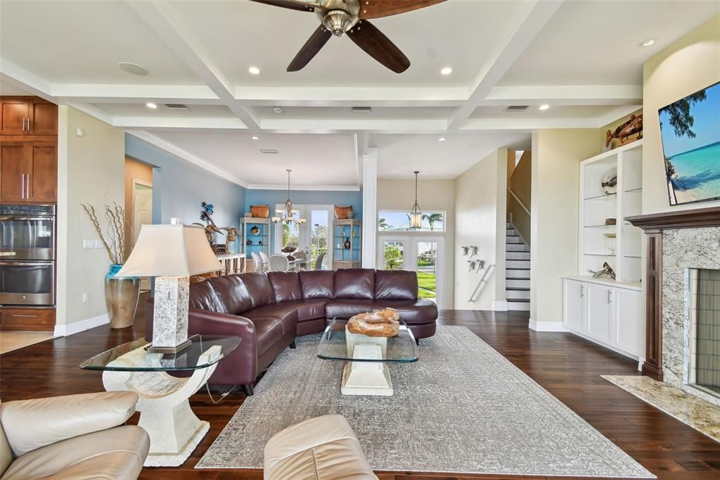 Chandelier, Dining room, Fireplace, Interior, Living room, Pendant Lights, Recessed Lighting, Wood Texture Flooring