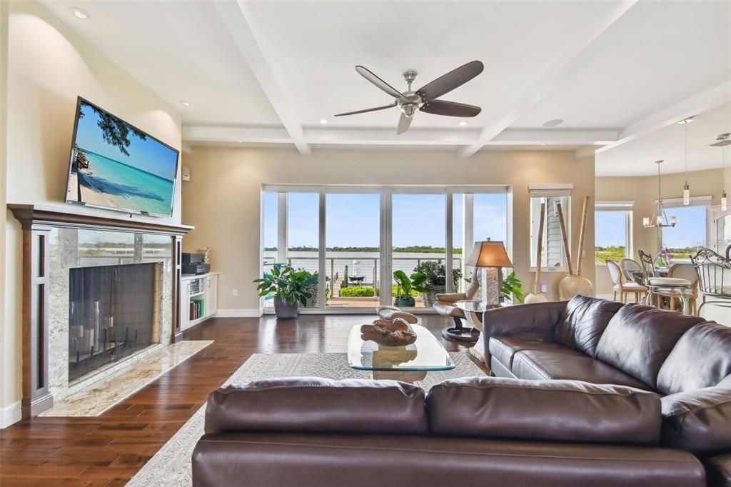 Dining room, Fireplace, Interior, Living room, Pendant Lights, Recessed Lighting, Water, Wood Texture Flooring