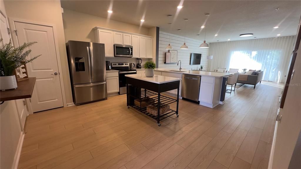 Dining room, Interior, Kitchen, Pendant Lights, Recessed Lighting, Stainless Steel Appliances, Wood Texture Flooring