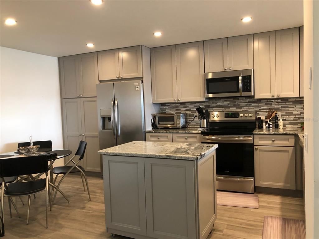Dining room, Interior, Kitchen, Recessed Lighting, Stainless Steel Appliances, Wood Texture Flooring