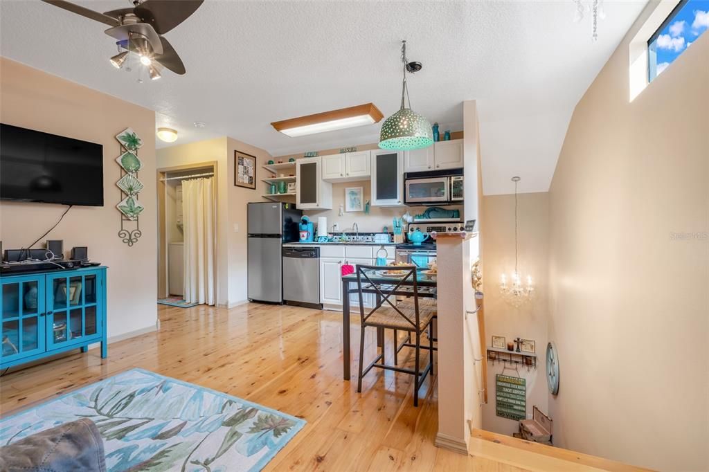 Chandelier, Dining room, Interior, Kitchen, Pendant Lights, Stainless Steel Appliances, Wood Texture Flooring