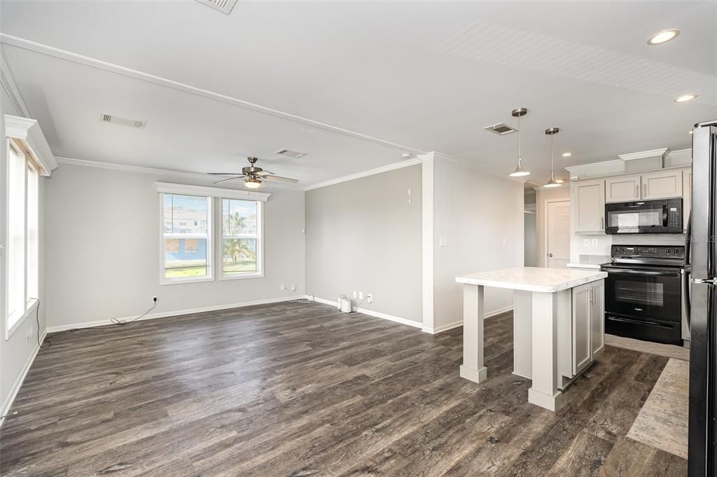 Empty room, Interior, Kitchen, Pendant Lights, Recessed Lighting, Stainless Steel Appliances, Wood Texture Flooring