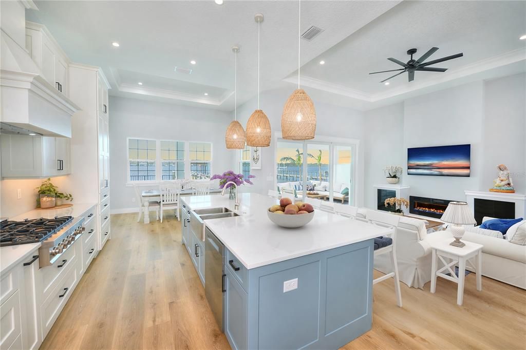 Dining room, Fireplace, Interior, Kitchen, Living room, Pendant Lights, Recessed Lighting, Stainless Steel Appliances, Water, Wood Texture Flooring