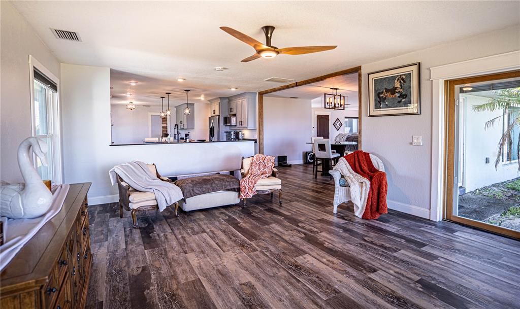 Chandelier, Dining room, Interior, Kitchen, Living room, Pendant Lights, Stainless Steel Appliances, Wood Texture Flooring