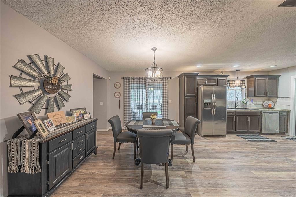 Dining room, Interior, Kitchen, Pendant Lights, Recessed Lighting, Stainless Steel Appliances, Wood Texture Flooring