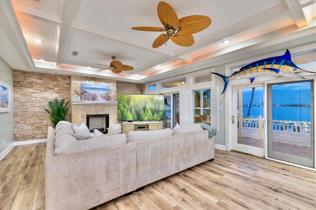 Fireplace, Interior, Living room, Recessed Lighting, Stone Walls, Water, Wood Texture Flooring