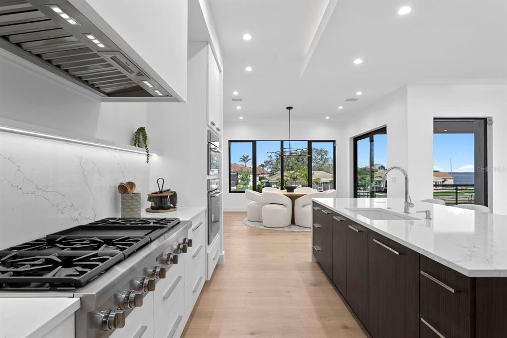 Dining room, Interior, Kitchen, Marble Walls, Pendant Lights, Recessed Lighting, Stainless Steel Appliances, Water, Wood Texture Flooring