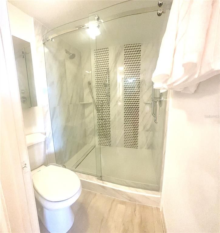 Bathroom, Glass Shower, Interior, Marble Walls, Wood Texture Flooring