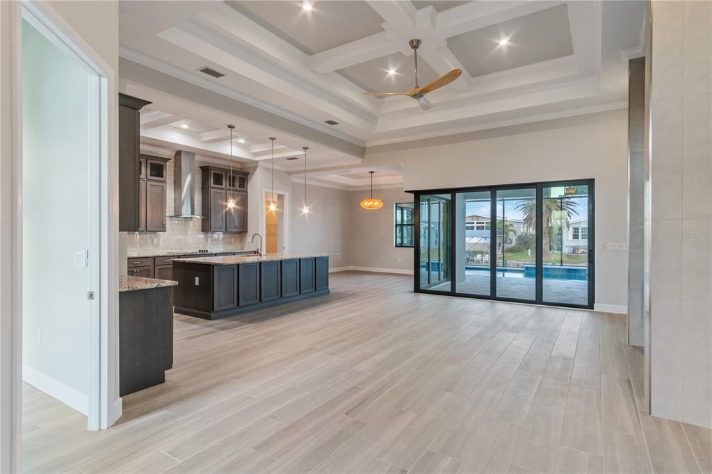 Empty room, Interior, Kitchen, Pendant Lights, Recessed Lighting, Stainless Steel Appliances, Wood Texture Flooring