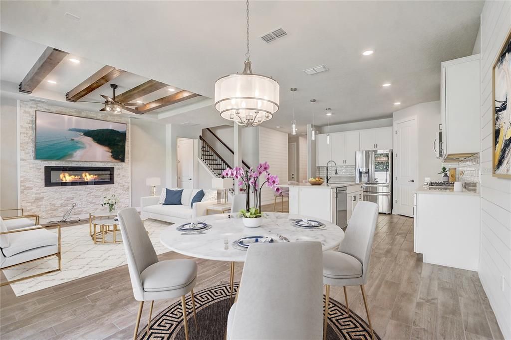Chandelier, Dining room, Fireplace, Interior, Kitchen, Living room, Pendant Lights, Recessed Lighting, Stainless Steel Appliances, Stone Walls, Wooden Beams, Wood Texture Flooring