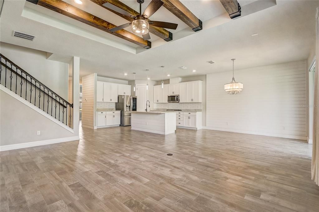 Empty room, Interior, Kitchen, Pendant Lights, Recessed Lighting, Stainless Steel Appliances, Wooden Beams, Wood Texture Flooring