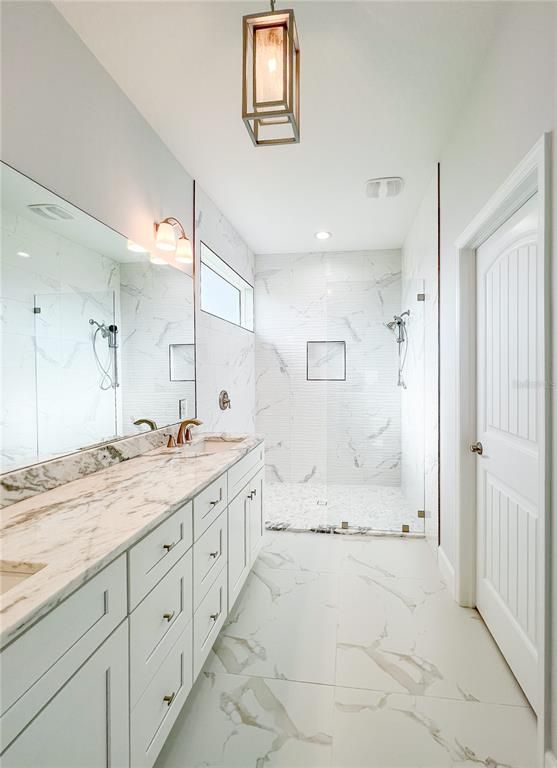 Bathroom, Dual Sink Vanities, Glass Shower, Interior, Marble, Marble Walls, Recessed Lighting