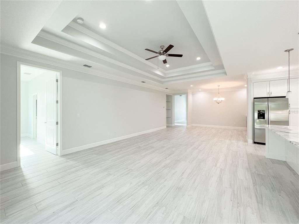 Chandelier, Empty room, Interior, Kitchen, Pendant Lights, Recessed Lighting, Stainless Steel Appliances, Wood Texture Flooring