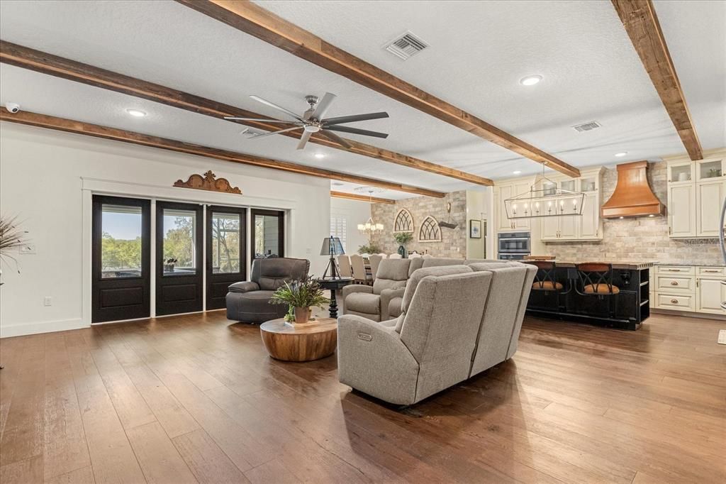 Chandelier, Fireplace, Interior, Kitchen, Living room, Recessed Lighting, Stone Walls, Wooden Beams, Wood Texture Flooring