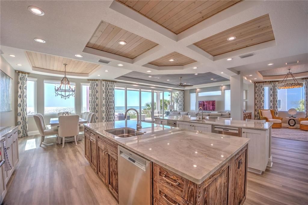 Chandelier, Dining room, Interior, Kitchen, Living room, Pendant Lights, Recessed Lighting, Stainless Steel Appliances, Water, Wooden Ceilings, Wood Texture Flooring