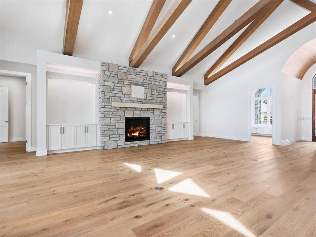 Empty room, Fireplace, Interior, Recessed Lighting, Stone Walls, Wooden Beams, Wood Texture Flooring