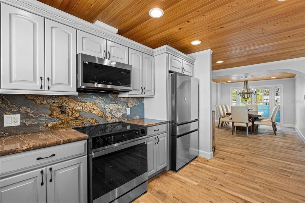 Chandelier, Dining room, Interior, Kitchen, Recessed Lighting, Stainless Steel Appliances, Wooden Ceilings, Wood Texture Flooring