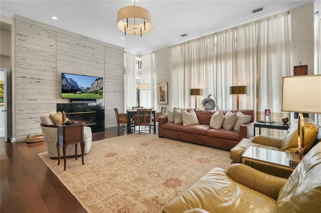 Chandelier, Dining room, Fireplace, Interior, Living room, Pendant Lights, Recessed Lighting, Wood Texture Flooring