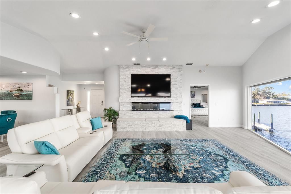 Fireplace, Interior, Living room, Recessed Lighting, Stone Walls, Water, Wood Texture Flooring