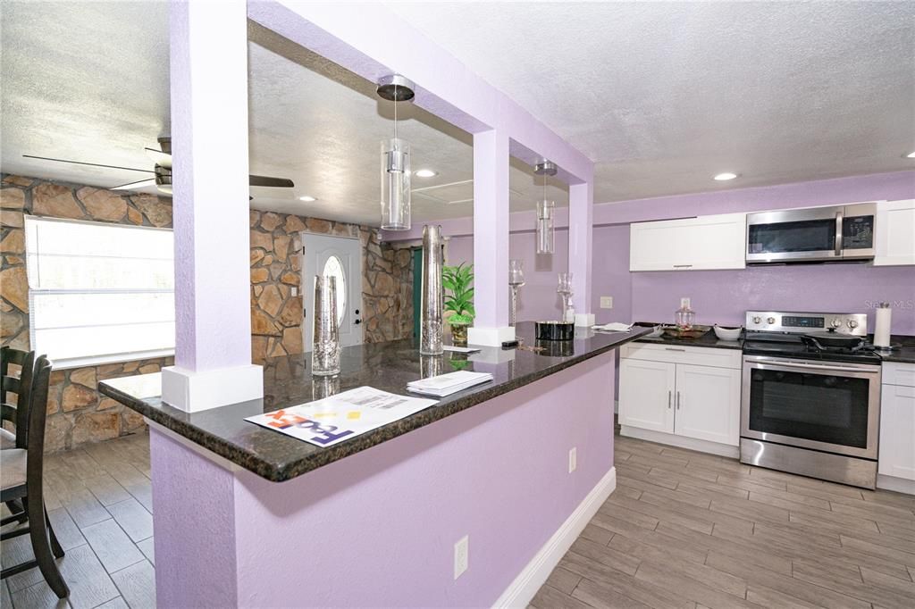 Interior, Kitchen, Pendant Lights, Recessed Lighting, Stainless Steel Appliances, Stone Walls, Wood Texture Flooring