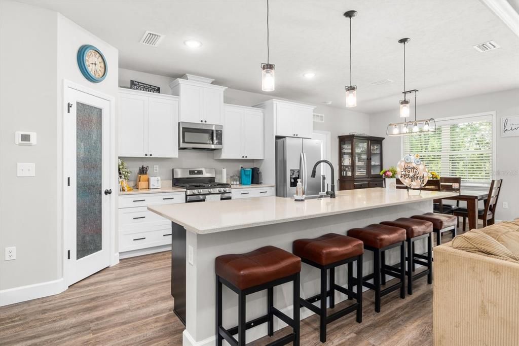 Dining room, Interior, Kitchen, Pendant Lights, Recessed Lighting, Stainless Steel Appliances, Wood Texture Flooring