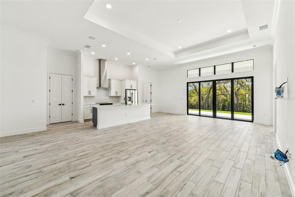 Empty room, Interior, Kitchen, Recessed Lighting, Stainless Steel Appliances, Wood Texture Flooring