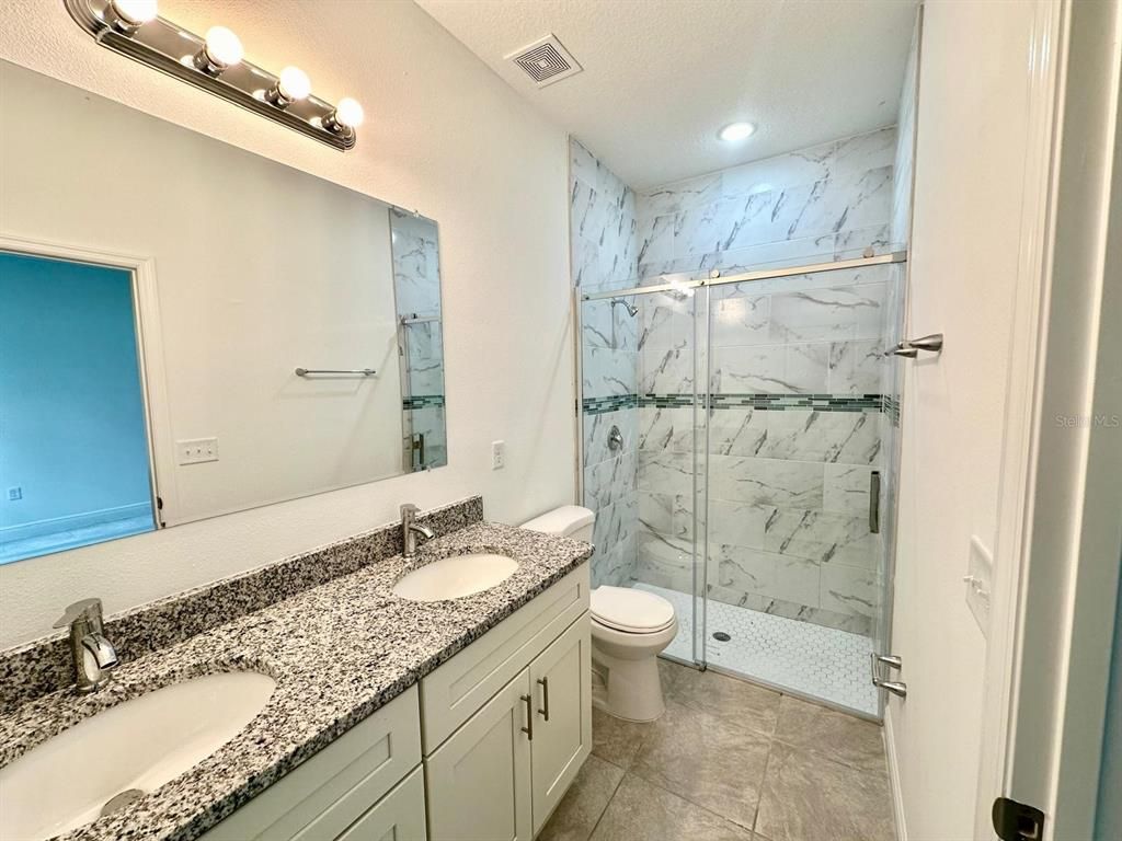 Bathroom, Dual Sink Vanities, Glass Shower, Interior, Marble Walls, Recessed Lighting