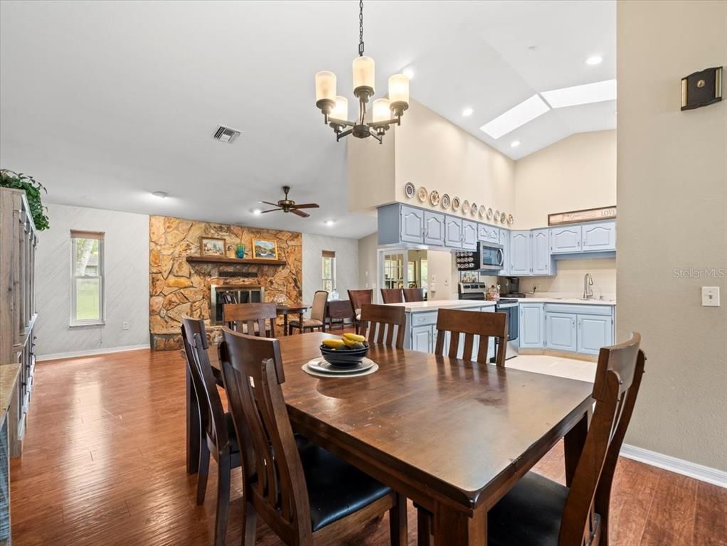 Chandelier, Dining room, Fireplace, Interior, Kitchen, Recessed Lighting, Stone Walls, Wood Texture Flooring