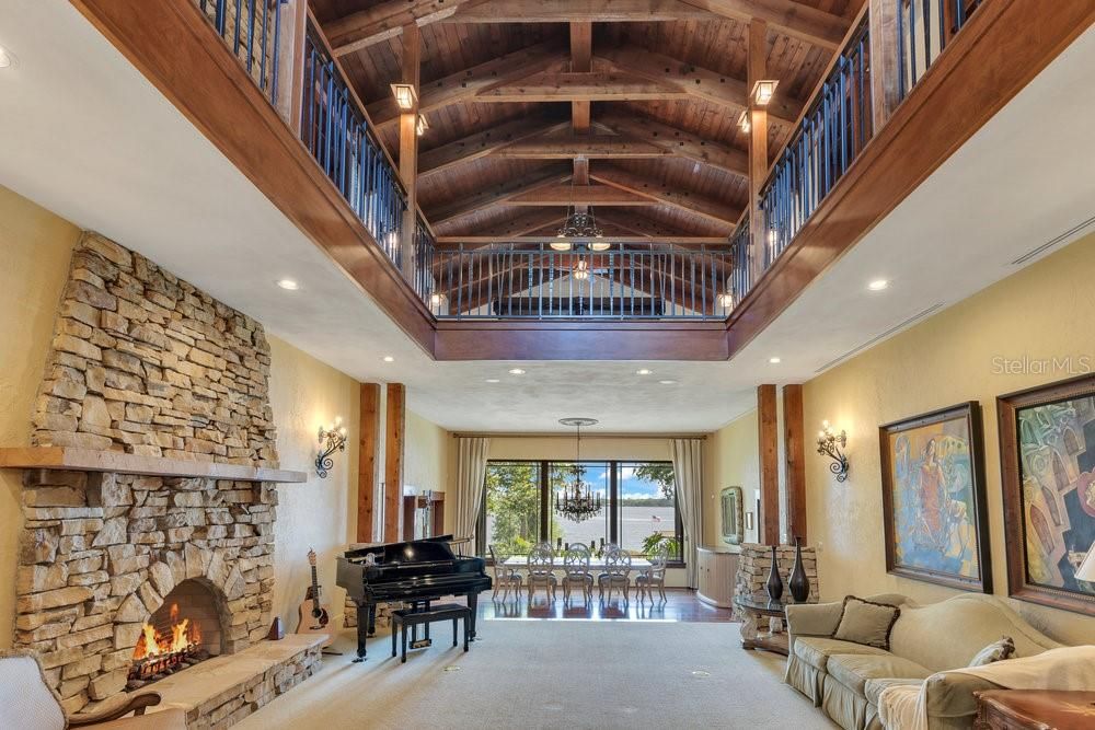 Chandelier, Fireplace, Interior, Living room, Piano, Recessed Lighting, Stone Walls, Wooden Beams, Wooden Ceilings
