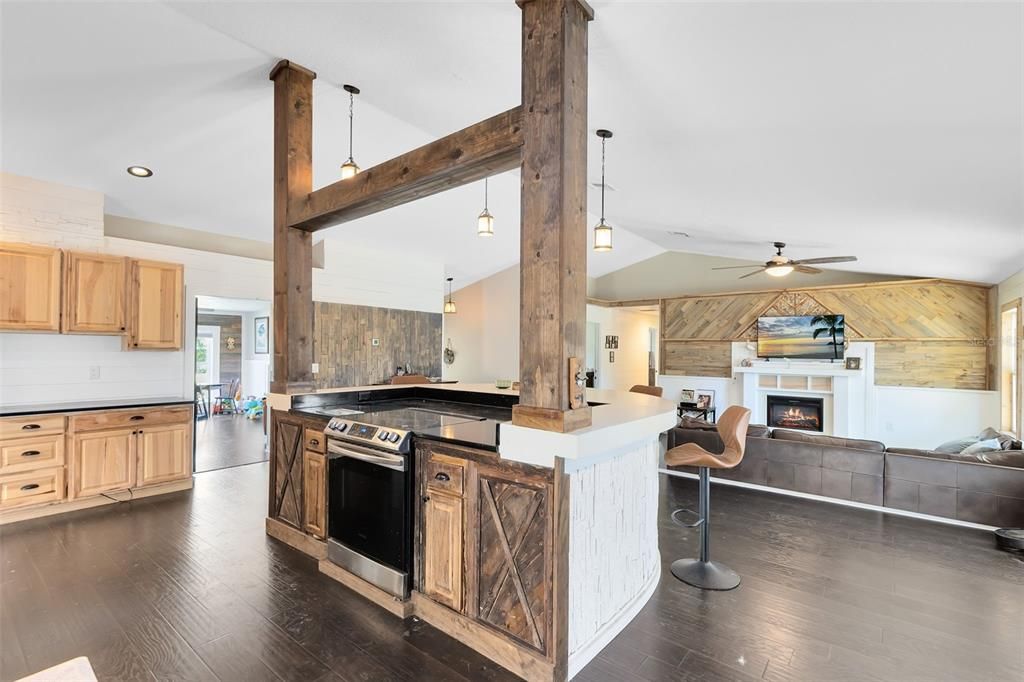 Fireplace, Interior, Kitchen, Pendant Lights, Recessed Lighting, Stainless Steel Appliances, Wood Texture Flooring, Wooden Walls