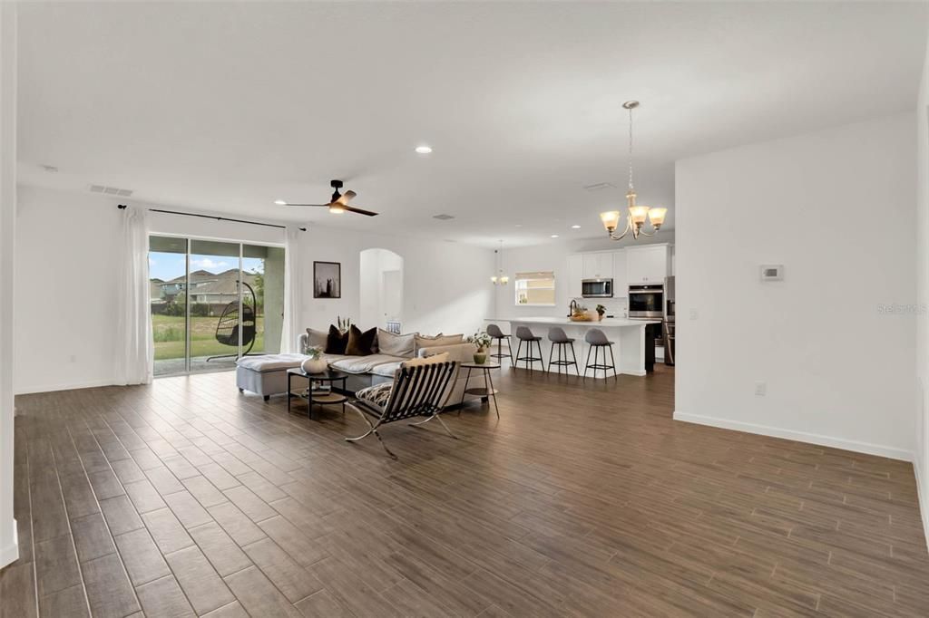 Chandelier, Dining room, Interior, Kitchen, Living room, Pendant Lights, Recessed Lighting, Stainless Steel Appliances, Wood Texture Flooring