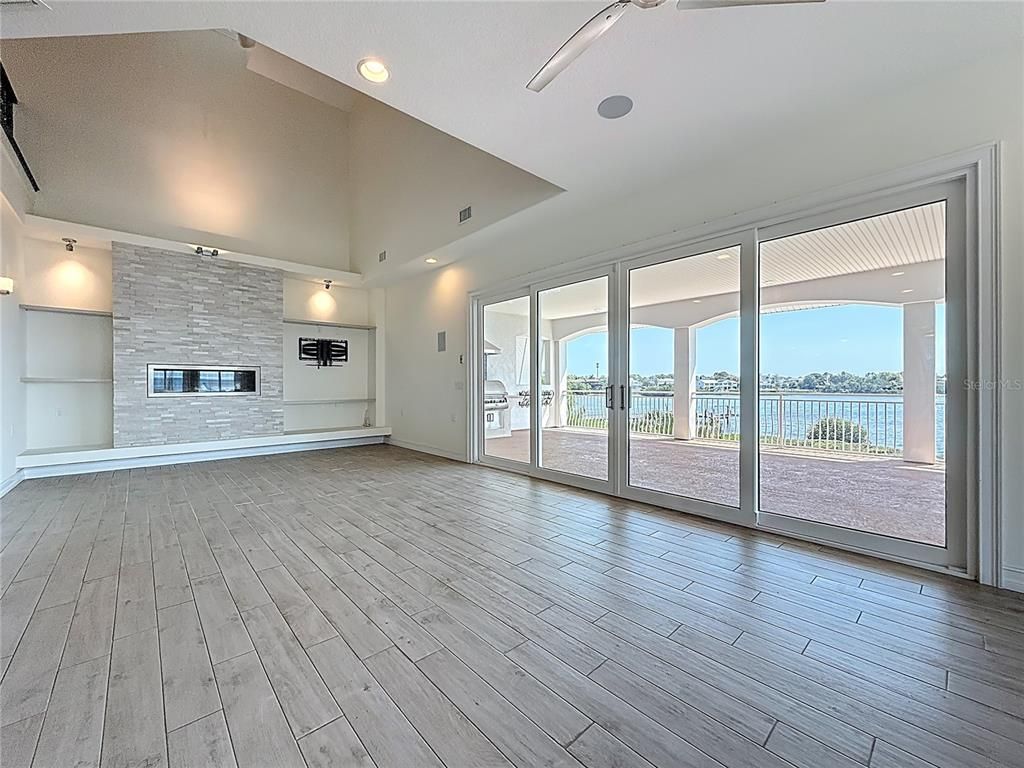 Empty room, Fireplace, Interior, Recessed Lighting, Water, Wood Texture Flooring