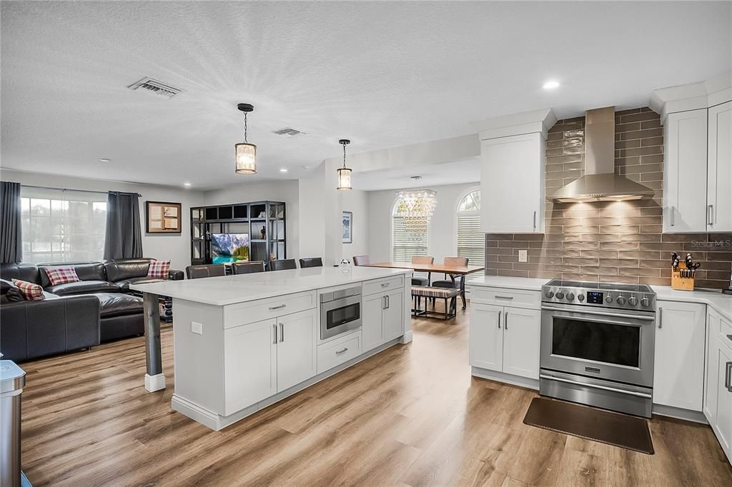 Dining room, Interior, Kitchen, Living room, Pendant Lights, Recessed Lighting, Stainless Steel Appliances, Wood Texture Flooring