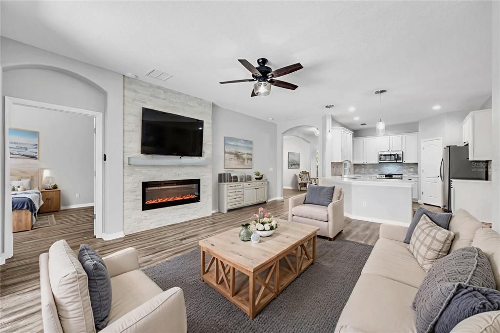 Fireplace, Interior, Kitchen, Living room, Pendant Lights, Recessed Lighting, Stainless Steel Appliances, Stone Walls, Wood Texture Flooring