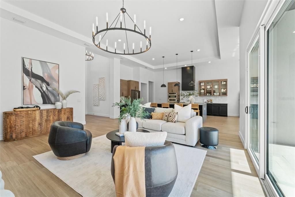 Chandelier, Interior, Kitchen, Living room, Pendant Lights, Recessed Lighting, Stainless Steel Appliances, Wood Texture Flooring