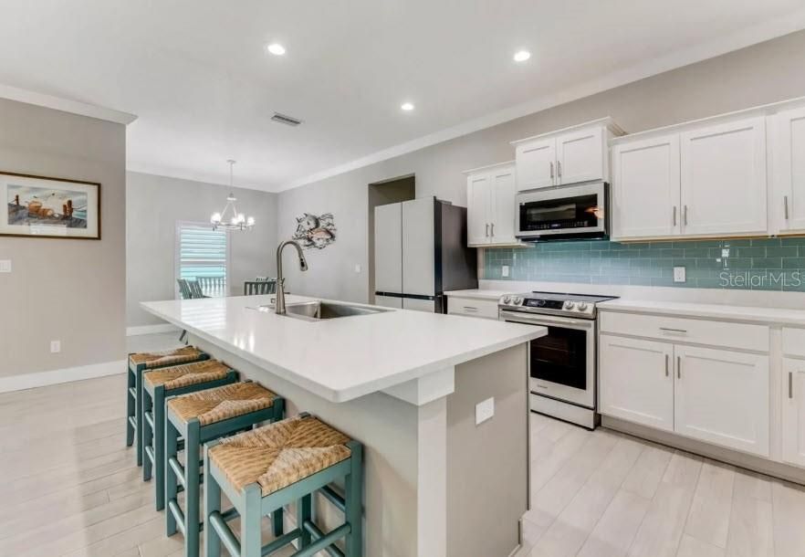 Chandelier, Interior, Kitchen, Pendant Lights, Recessed Lighting, Stainless Steel Appliances, Wood Texture Flooring