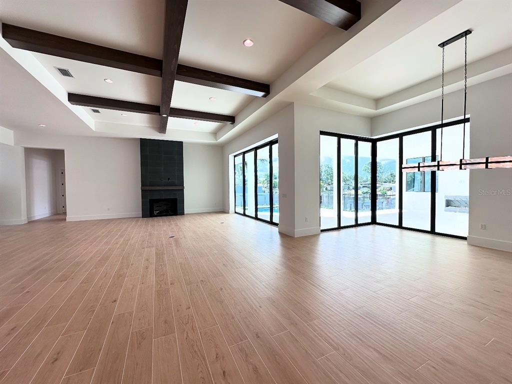 Empty room, Fireplace, Interior, Pendant Lights, Recessed Lighting, Wooden Beams, Wood Texture Flooring