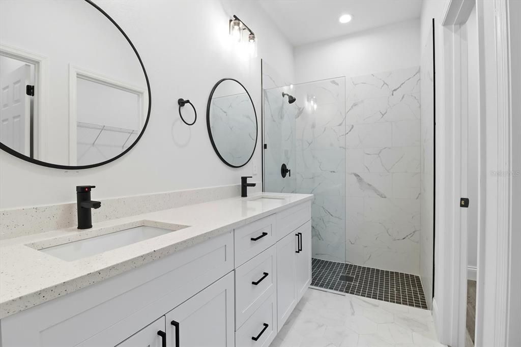 Bathroom, Dual Sink Vanities, Glass Shower, Interior, Marble, Marble Walls, Recessed Lighting