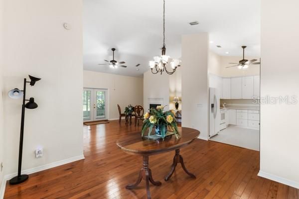 Chandelier, Dining room, Empty room, Fireplace, Interior, Kitchen, Recessed Lighting, Wood Texture Flooring