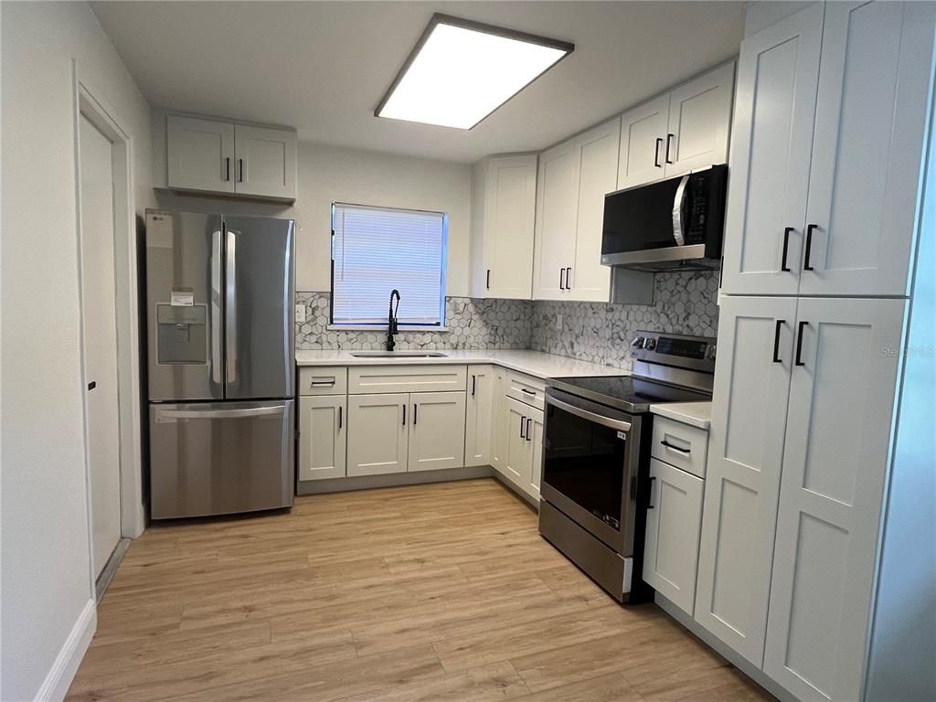 Interior, Kitchen, Marble Walls, Stainless Steel Appliances, Wood Texture Flooring