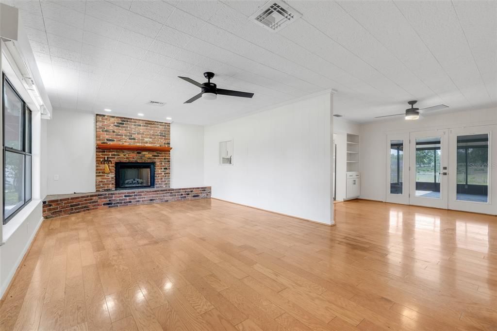 Empty room, Fireplace, Interior, Recessed Lighting, Stone Walls, Wood Texture Flooring