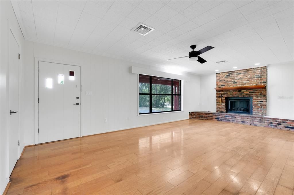Empty room, Fireplace, Interior, Recessed Lighting, Stone Walls, Wood Texture Flooring