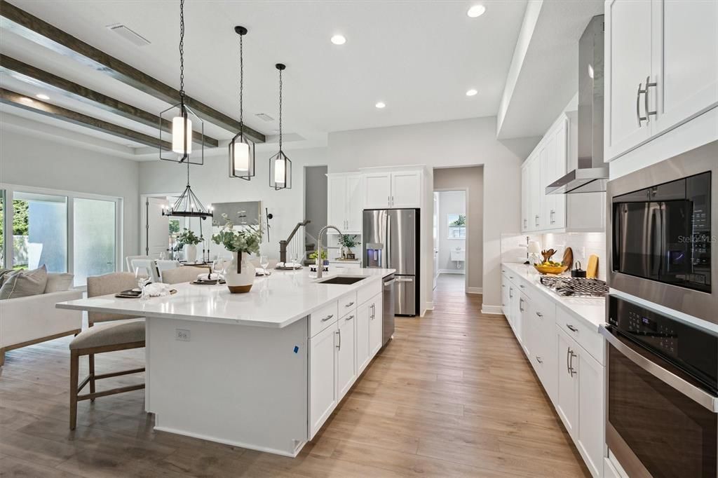 Dining room, Interior, Kitchen, Pendant Lights, Recessed Lighting, Stainless Steel Appliances, Wood Texture Flooring